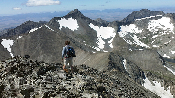 a hiker descends from Crazy Peak