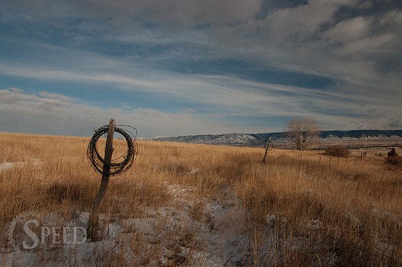 Roll of barbed wire on a fence post in Bighorn Canyon