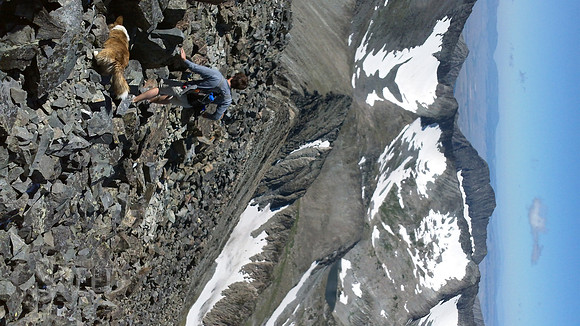 a hiker descends from Crazy Peak