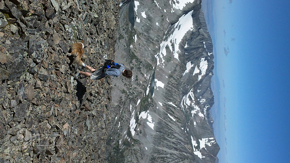 a hiker descends from Crazy Peak
