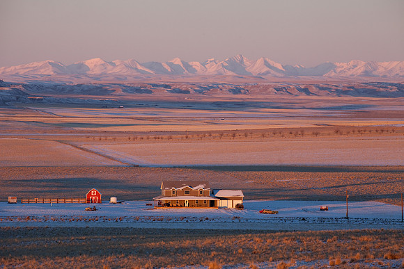 A homestead and the Crazy Mountains