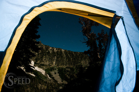Starry view from tent near blue lake.
