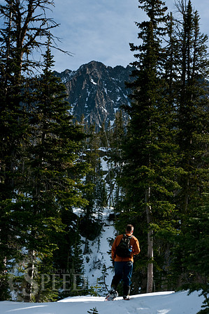 Snow shoe hiker in the Crazy Mountains near Blue Lake